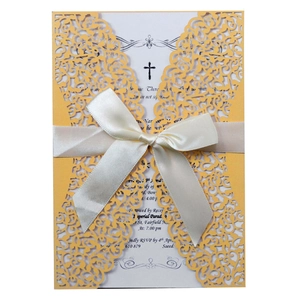 Laser cut wedding invitation in yellow with white ribbon and elegant floral pattern
