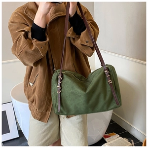 Olive green suede shoulder bag with adjustable brown leather straps and gold metal hardware