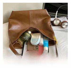 Vue intérieure du sac cabas vintage marron contenant une tablette et du maquillage