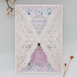 Detail of laser-cut white lace butterfly invitation with floral printed inner card
