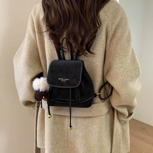 Retro black suede mini backpack for women with drawstring closure and white pompom charm