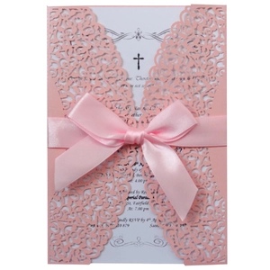 Pink laser cut wedding invitation card with floral vine pattern and a satin bow