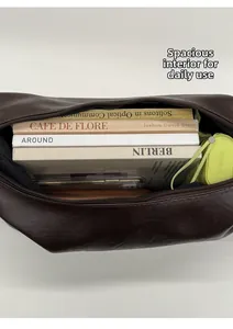 Interior view of brown dumpling bag showing large capacity for books and umbrella