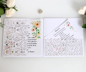 Macro detail of laser-cut floral wedding invitation with elegant hollow patterns