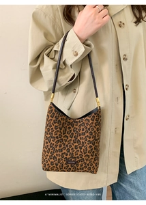 Close-up of leopard print tote bag featuring a leather No Filter tag and gold hardware