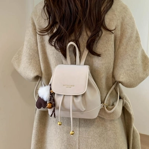 Retro cream faux suede mini backpack for women with drawstring and heart charm detail
