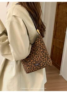 Detail of leopard print shoulder bag with black strap and metallic adjustment buckle
