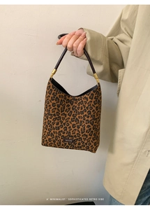Close-up of leopard print underarm bag with leather handle and NO FILTER logo tag
