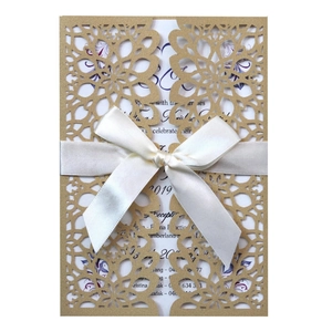 Laser-cut gold hollow wedding invitation with white silk ribbon and floral insert
