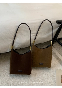 Macro view of minimalist suede underarm bags in dark coffee and retro brown leather