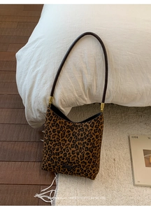 Detail of leopard print shoulder bag featuring gold hardware and No Filter metal plaque