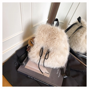 Detail der weichen Kunstfellstruktur am beigen Kordelzug-Rucksack mit Leoparden-Bär-Anhänger