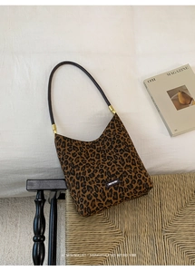 Close-up of leopard print bucket bag featuring NO FILTER tag and gold hardware