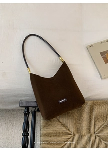 Detailed view of brown suede Hobo bag with gold hardware and NO FILTER text label