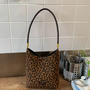 Detail of leopard print hobo bag with long strap and NO FILTER leather tag