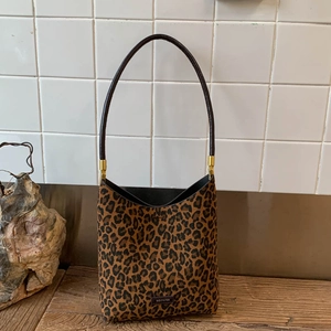 Detail of leopard print tote bag with brown straps and NO FILTER brand label