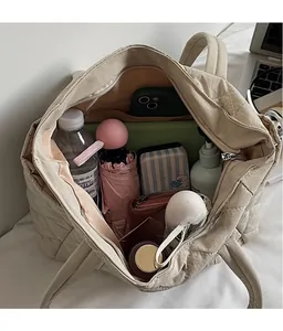 Detailed view of the beige quilted tote bag showing its spacious interior for daily essentials