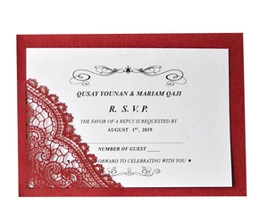 Detail of red laser-cut lace wedding invitation card with elegant floral hollow pattern