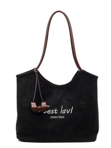 Black suede tote bag with white embroidery and brown handles for daily commute