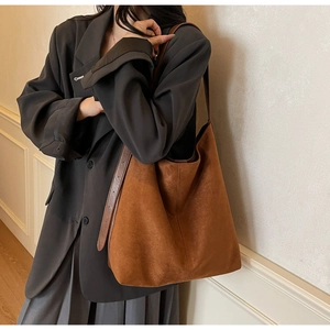Close-up of brown suede bucket bag showing soft texture and large capacity for daily commute