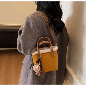 Detail of vintage plush bucket bag with fuzzy shearling trim and stylish fashion logo