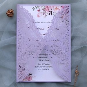 Detailed laser-cut lace wedding invitation cover in lavender with floral inner card