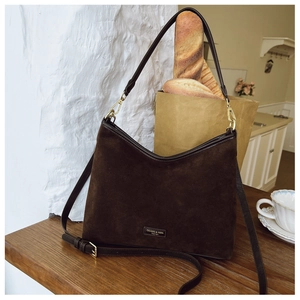 Dettaglio ravvicinato della texture della borsa tote in pelle scamosciata marrone scuro