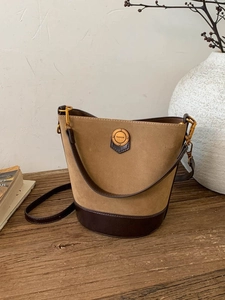 Vintage khaki suede bucket bag with brown leather trim and fashion metal hardware