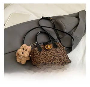 Mini leopard print handbag with golden twist lock and a cute plush dog pendant charm