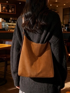Caramel brown vintage suede hobo bag featuring large capacity and vertical seam detail