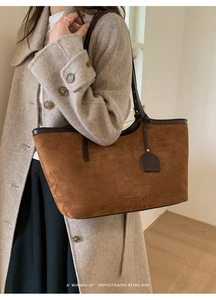 Close-up of brown suede tote bag featuring premium leather trim and a minimalist retro vibe