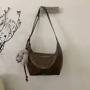 Brown vintage oil-wax leather hobo bag with cute plush rabbit keychain accessory