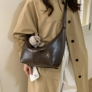 Detailed view of dark brown PU leather crossbody bag with cute plush rabbit charm