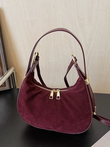 Deep wine red crescent handbag with suede texture and gold ring hardware detail