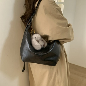 Retro black faux leather hobo bag for women featuring a cute grey plush rabbit pendant