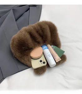 Internal view of brown faux fur handbag showing spacious storage for phone and cosmetics