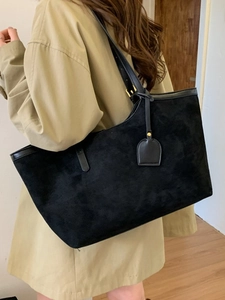 Minimalist large black suede tote bag for women shown with model in casual commute style
