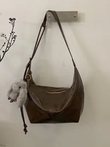 Retro brown oil wax leather hobo shoulder bag featuring a cute plush bunny pendant