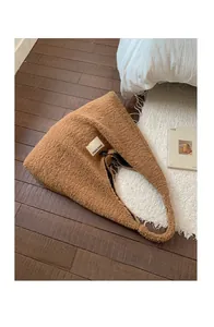Detailed view of brown teddy fleece tote bag featuring a SEEYOU cloth label and spacious interior