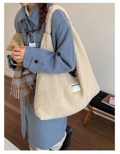 Detailed look at fluffy cream fleece tote bag with a SEEYOU label on a blue coat model