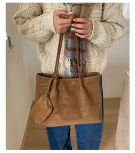 Brown faux leather tote bag with matching pouch and long shoulder straps for daily commute