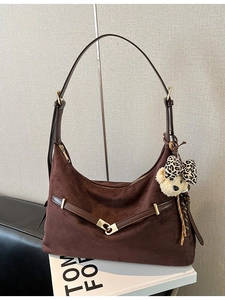 Dark brown matte dumpling shoulder bag with crescent shape and plush bear pendant