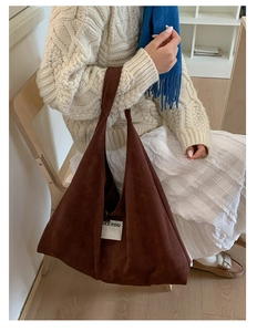 Detail of deep brown suede hobo bag texture with a minimalist SEEYOU brand tag