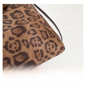 Macro shot of faux suede leopard print fabric texture and reinforced stitching details