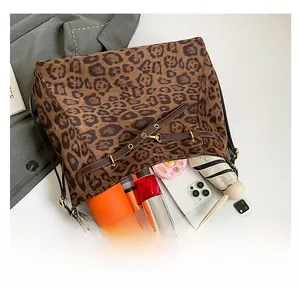 Spacious leopard print tote bag interior showing capacity for umbrella, tablet and bottle