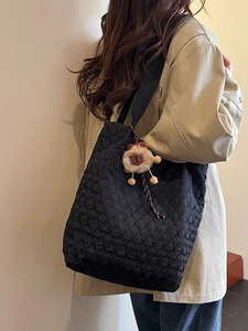 Large black quilted tote bag with lion plush charm for casual daily commuting and travel