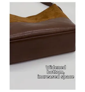 Detail of the widened bottom base of brown bucket bag showing two-tone material texture