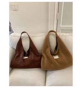 Detail of dark brown leather and caramel faux fur Hobo bags with Seeyou woven label