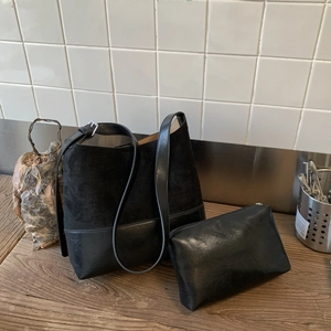 Detail of black matte bucket bag set with inner pouch and adjustable leather strap