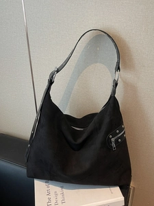 Black faux suede hobo bag with silver zippers and rivets in retro motorcycle style